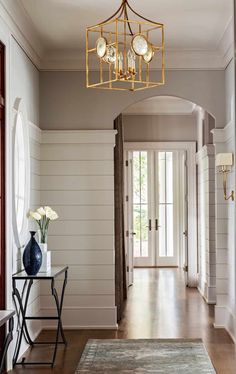 the hallway is clean and ready for guests to use it as an entrance way in this home