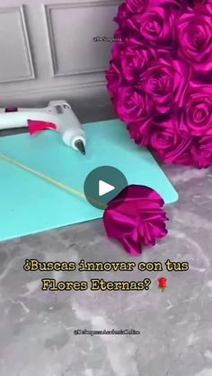 the video shows how to make a flower arrangement with pink roses and glue on it