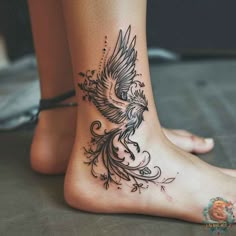 a woman's foot with a bird tattoo on it