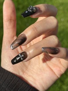 This nail art design combines the mystery of black with the modern touch of silver, showcasing a dark gothic style. The 3D cross and stripes on the nails add depth and visual impact, adding a unique charm to the overall look. This design is suitable for both everyday wear and can be paired with special occasion outfits, showcasing a blend of personality and fashion-forward allure. Every package contains 10 pcs well made press on nails, liquid glue, jelly glue, mini file and a wooden stick Gothic Nail Charms, Cross Gem Nails, Gothic Nails Square, Clear Black Nails, Black 3d Nails, Gothic Nails Black, Cross Charm Nails, Black Cross Nails, Nail Cross Design