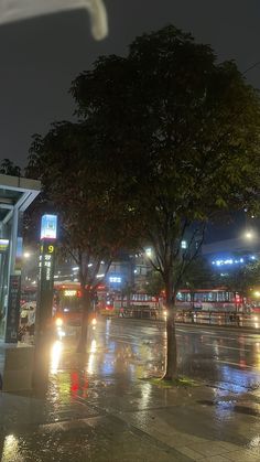 the city street is wet with rain at night