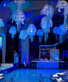 a room filled with lots of blue lights and chandeliers hanging from the ceiling