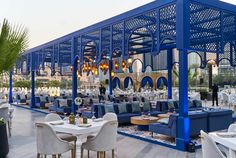 an outdoor dining area with blue and white furniture