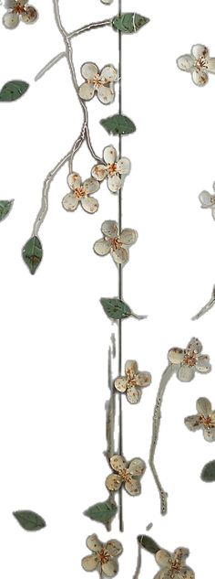 a metal sculpture with flowers and leaves hanging from it's sides on a white background