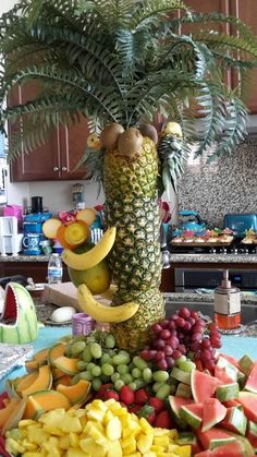 a fruit platter with bananas, watermelon, grapes and pineapples