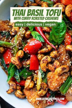 thai basil tofu with curry roasted cashews is shown in a white bowl