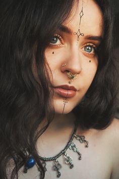 a woman with piercings on her nose and chest