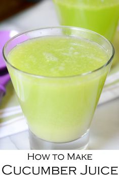 two glasses filled with cucumber water sitting on top of a white tablecloth