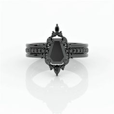 a black diamond engagement ring set on a white background with the center stone surrounded by smaller diamonds