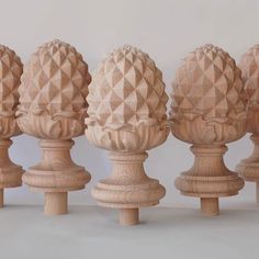 six wooden sculptures are lined up in a row