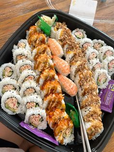 sushi platter with various types of sushi and chopsticks on it