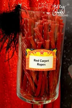 red carpet ropes in a clear glass container