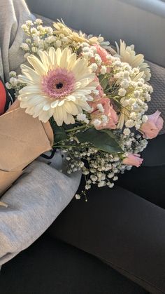 a bouquet of flowers sitting on the back seat of a car