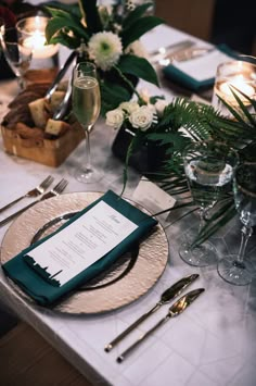 the table is set with silverware and green napkins