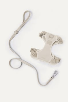 the strap is attached to an electronic device on a white surface with a gray cord