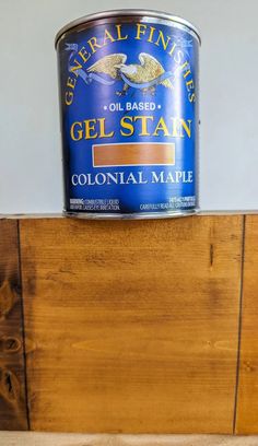 a can of gel stain sitting on top of a wooden shelf next to a wall