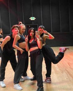 a group of young women standing on top of a wooden floor next to each other