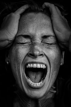 a woman holding her head with both hands