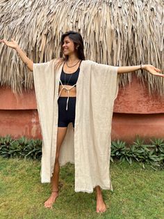 Open long kimono robe in beige handmade from natural textiles - original threads. Crafted from eco-friendly hemp fibers, it offers exceptional comfort and durability. Ideal for lounging at home, its natural breathability ensures comfort throughout the year. Each robe is made with care for quality and timeless style, appealing to our conscious community that values comfort and sustainability.  Elevate your loungewear with this versatile hemp robe, blending eco-conscious materials with expert craf Bohemian Beige Kimono For Beach Cover-up, Beige Bohemian Kimono For Beach Cover-up, Long Beige Kimono For Festival, Beige Long Kimono For Festival, Cream Beach Kimono With Kimono Sleeves, Cream Summer Kimono For The Beach, Bohemian Beach Robe With Natural Dye, Cream Summer Beach Kimono, Beige Bohemian Long Kimono