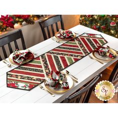 a table set with place mats, plates and napkins for christmas dinner or special occasion