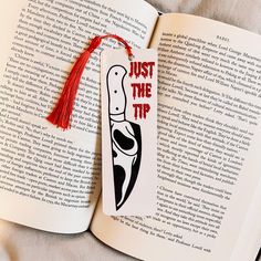 an open book with a red tassel hanging from it's cover and the title just the tip