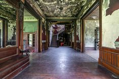 an empty hallway with wooden railings and painted walls on both sides, leading to the second floor