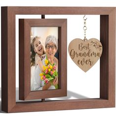 a wooden frame with a heart shaped keychain attached to it and a photo hanging from the front