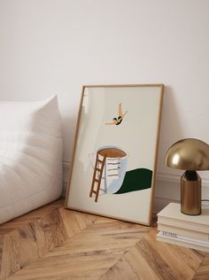 there is a framed photograph on the floor next to books and a lamp with a bird above it