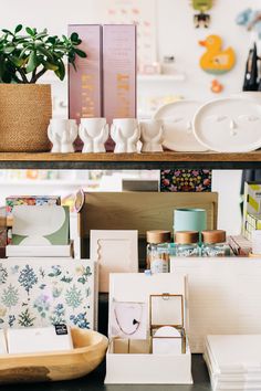 there are many items on the shelves in this room, including cards and boxes that have been placed together