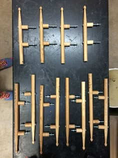 several wooden pegs are arranged in the shape of an x on a black board