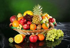 a basket filled with lots of different types of fruit sitting on top of a table