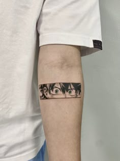 a person with a tattoo on their arm has an image of two eyes behind them