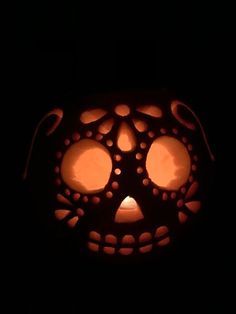 a pumpkin carved to look like a face with eyes on it's side in the dark