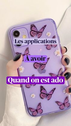 a woman holding a purple phone case with butterflies on it and the words les application