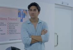 a man standing with his arms crossed in front of a whiteboard that says conditions treated