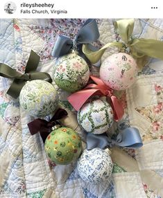 an arrangement of decorative ornaments is displayed on a quilted bed spread with ribbons and bows