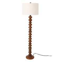 a wooden floor lamp with a white shade on the base and a cord attached to it