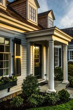 a white house with black shutters and windows