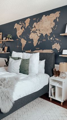 a bedroom with a large map on the wall above the bed, and shelving