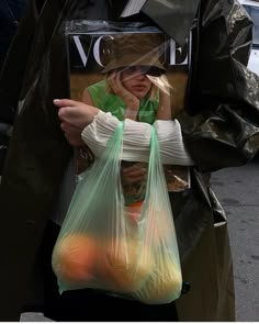 a woman holding a plastic bag with an instagram message on the front and bottom