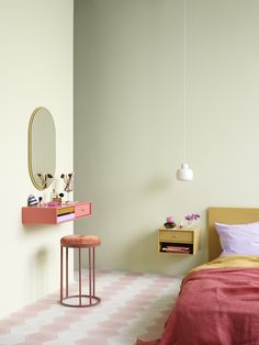 a pink and white bedroom with a bed, desk, mirror and stool in it