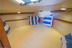 the interior of a sailboat with two pillows