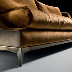 a brown couch sitting on top of a gray floor