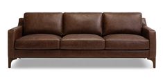 a brown leather couch sitting on top of a white floor