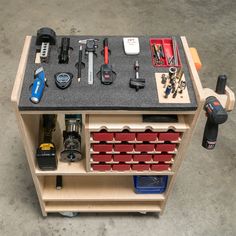 a workbench with tools and other items on the top shelf, including screwdrivers