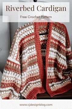 a red and white crocheted cardigan sitting on top of a table