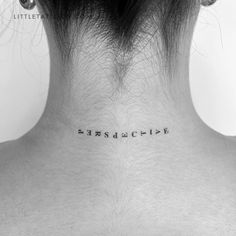 the back of a woman's neck with words written in cursive font