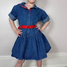 Totally 80s kids denim dress! It snaps up the front. It has a drop waist but there are belt loops and a belt at the natural waist. The sleeves are 3/4 length and I think that they are meant to be rolled up. That's how it looked best on my daughter. In true 80s fashion, there are shoulder pads. The fabric has a slight sparkle. Brand - Oops Too California Content - 100% Cotton Denim Size - Labeled Size 6X - The model in the photos is 5 1/2 and it fit her well with room too grow - Check all measurements to ensure fit Shoulders - 12.5" across Chest - 14.25" pit to pit  Sleeves - 9.75" from shoulder seam Waist - 13.25" across but you can cinch it in with the belt Length - 22.5" (the belt loops hit about 10-11.5" down) Condition - I don't see any flaws on the dress but the belt has some fraying Kids Denim Dress, Totally 80s, Jean Vintage, Red Belt, Memphis Tn, 1980s Fashion, Kids Denim, 80s Fashion, Drop Waist