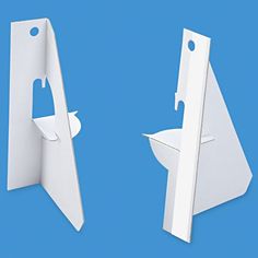 two white toilet paper dispensers with one open and the other closed, on a blue background