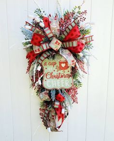 a christmas wreath hanging on the side of a door